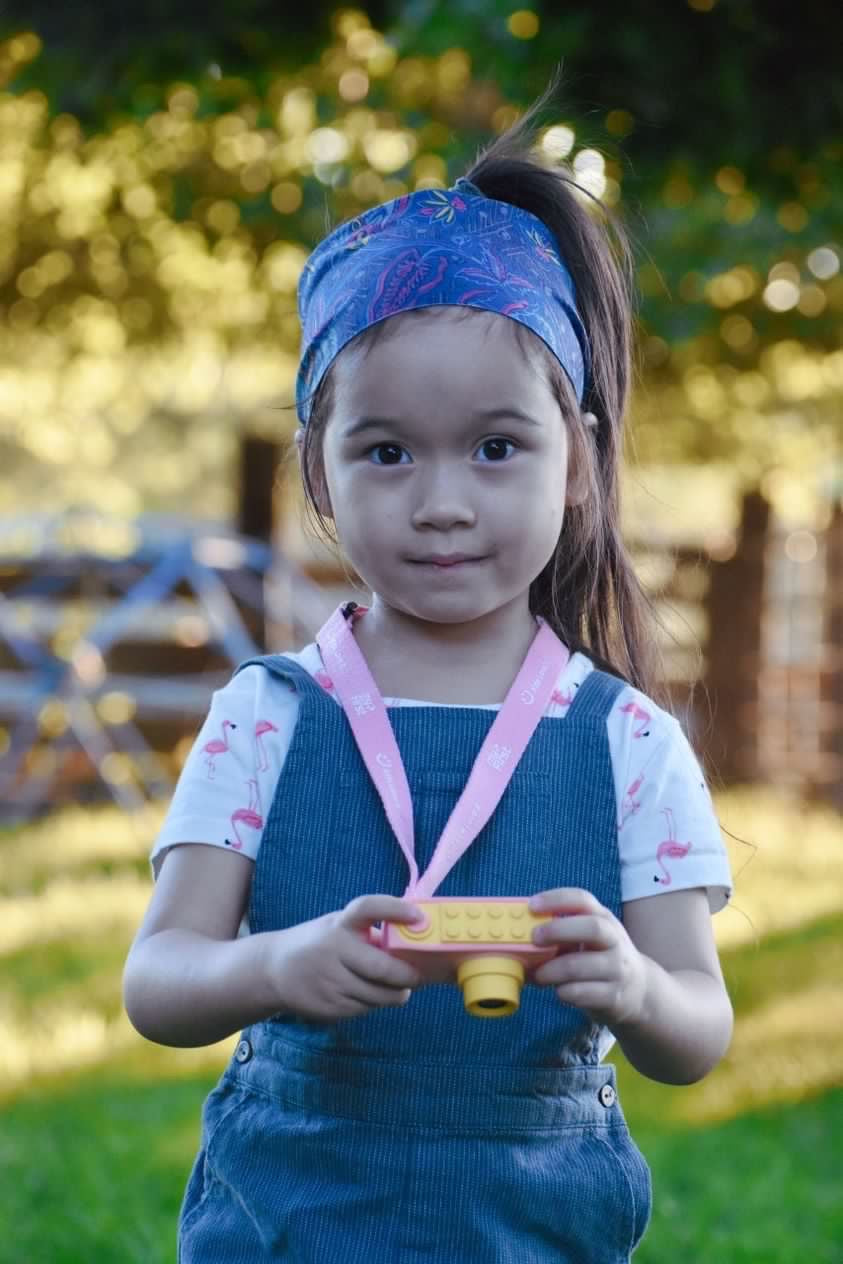 girl using pink kids action camera