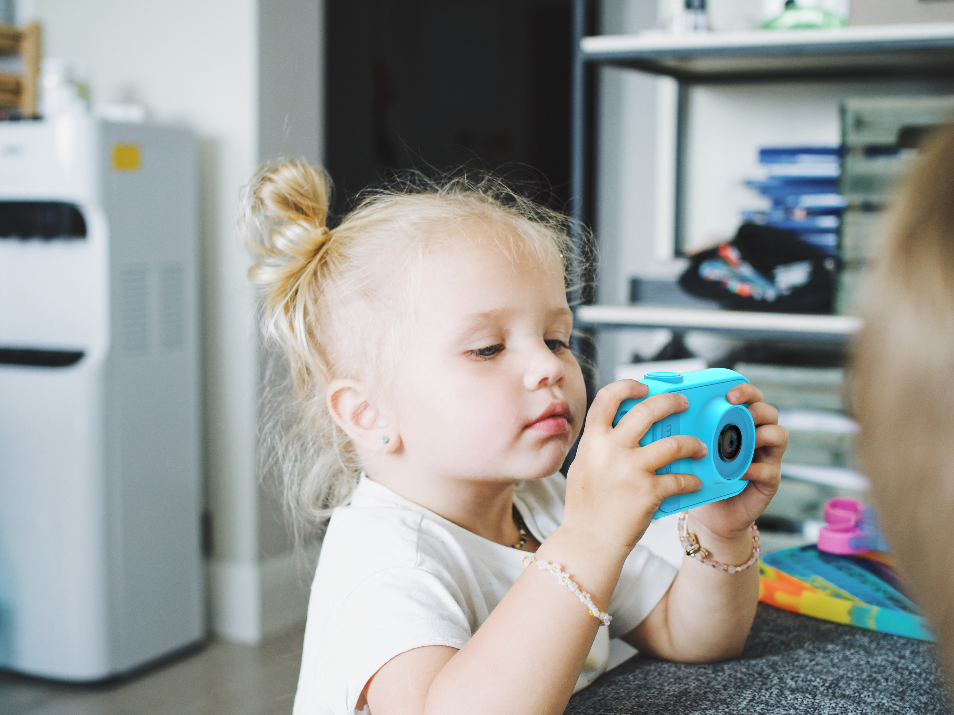 Toddler with blue digital camera for kids as young as 3 years old made by myFirst creating safe kids products