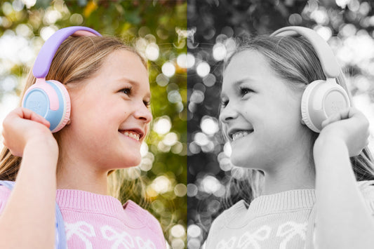 An image featuring the same girl, one side in color, the other in black and white, while they wear headphones and look at each other.