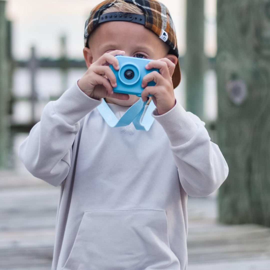 boy taking a picture with the myfirst camera for kids in blue