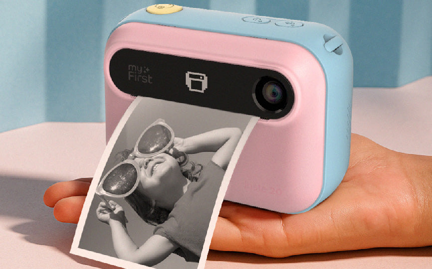myFirst Insta 20 kids instant camera printing a black-and-white photo, for small hands—compact, no-ink thermal printing for ages 4 and up.