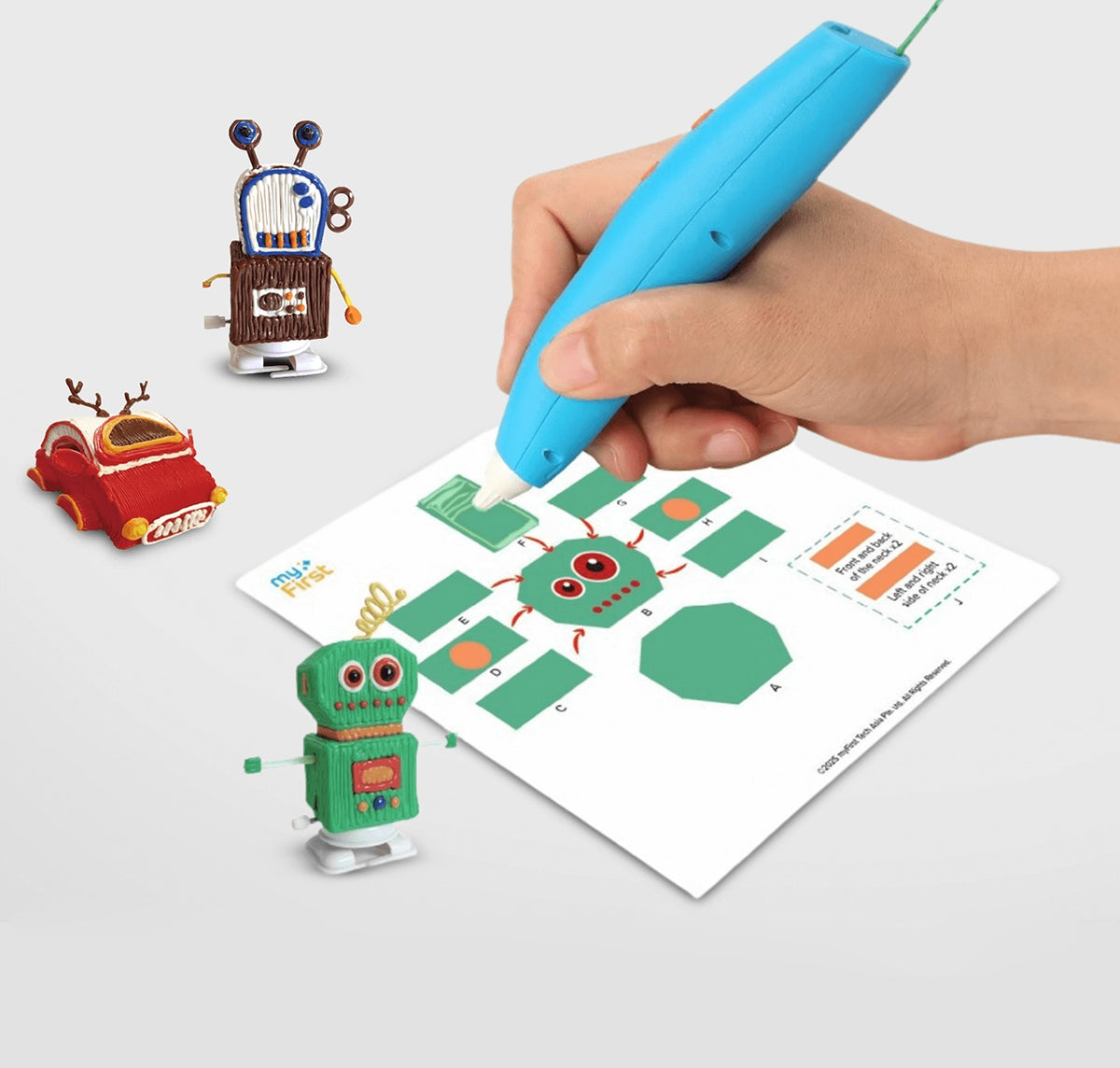 myFirst 3dPen Make blue 3D pen held by a hand, tracing a green template to build colorful 3D toys like robots and cars.
