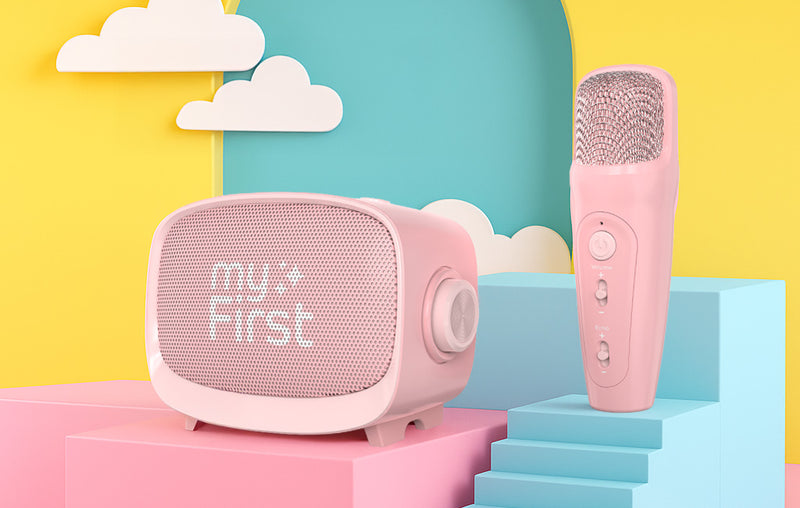 myFirst Voice 2 kids karaoke microphone and wireless bluetooth speaker set in pink, shown on a colorful pastel stage — designed for safe, fun music parties and sleepover for children.